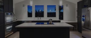 quartz worktops in kitchen with night time view from windows