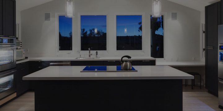 quartz worktops in kitchen with night time view from windows